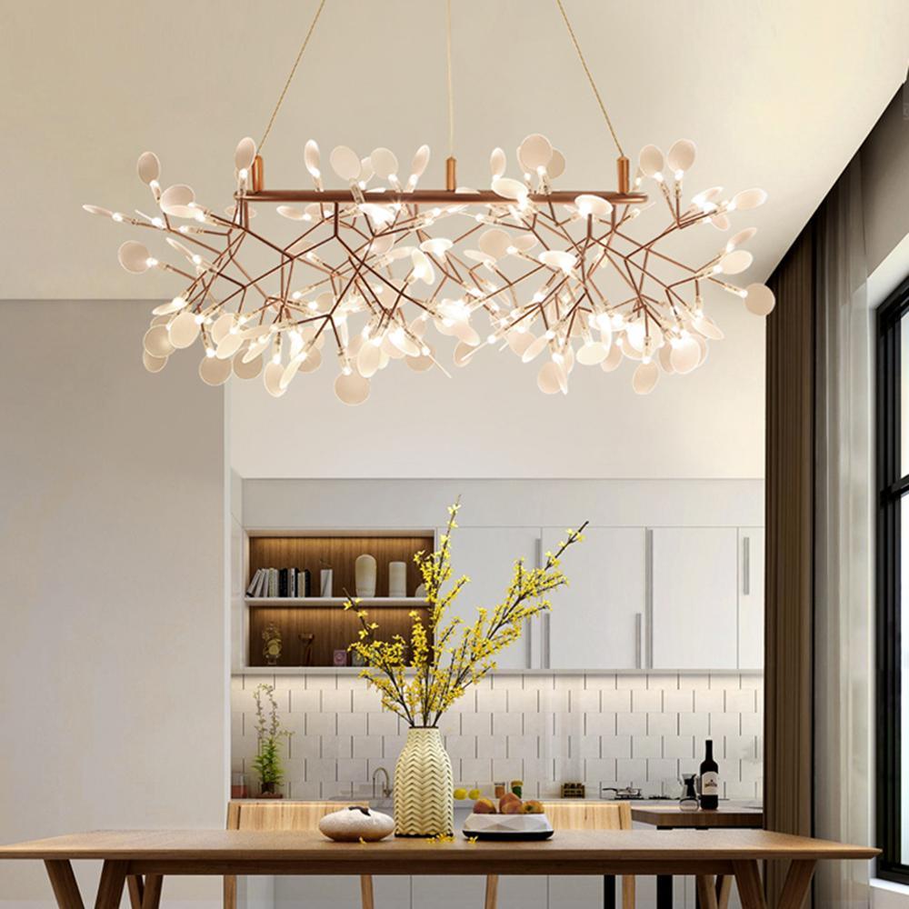 Rose gold firefly chandelier glowing in a styled room