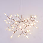 Rose gold firefly chandelier with leaves in a wide spread