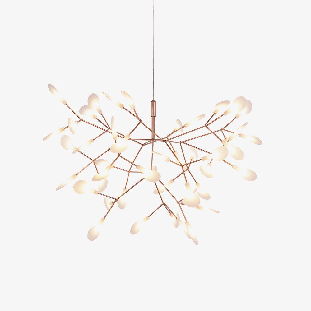 Branching rose gold LED chandelier lit in a dim room