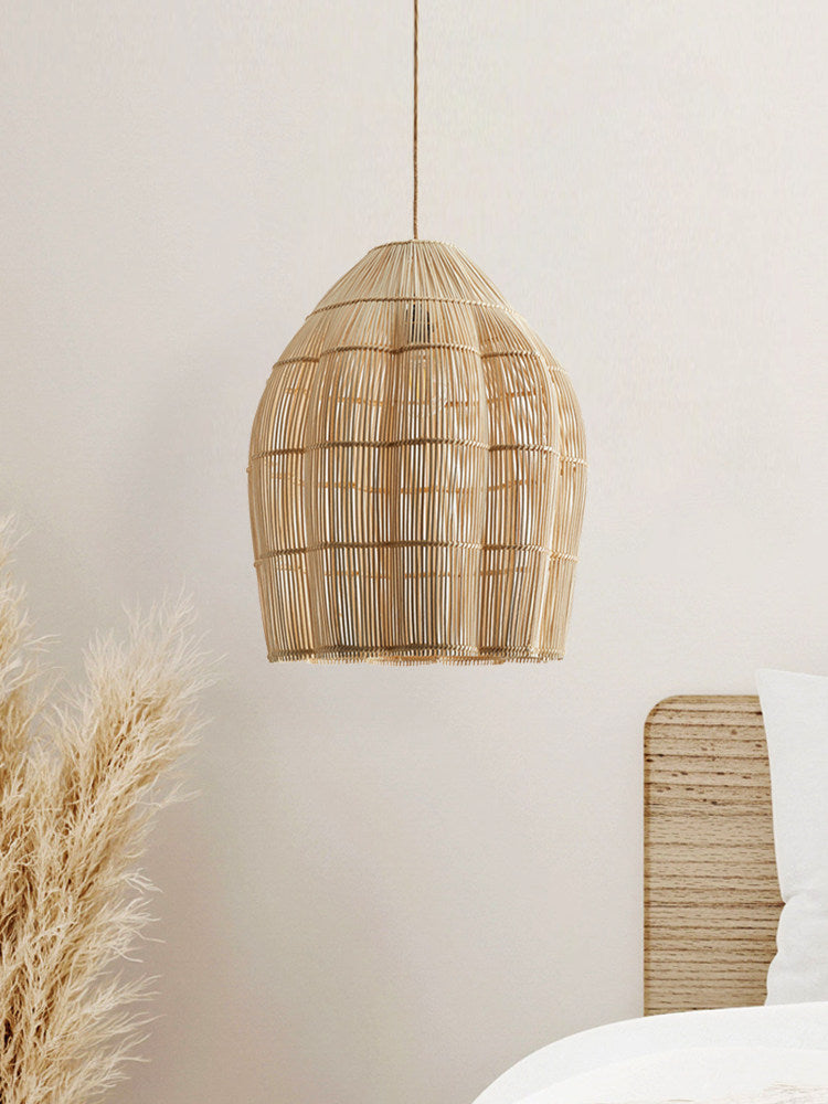 This Clérachic pendant hangs against a plain white wall, beside a spray of dried pampas grass.