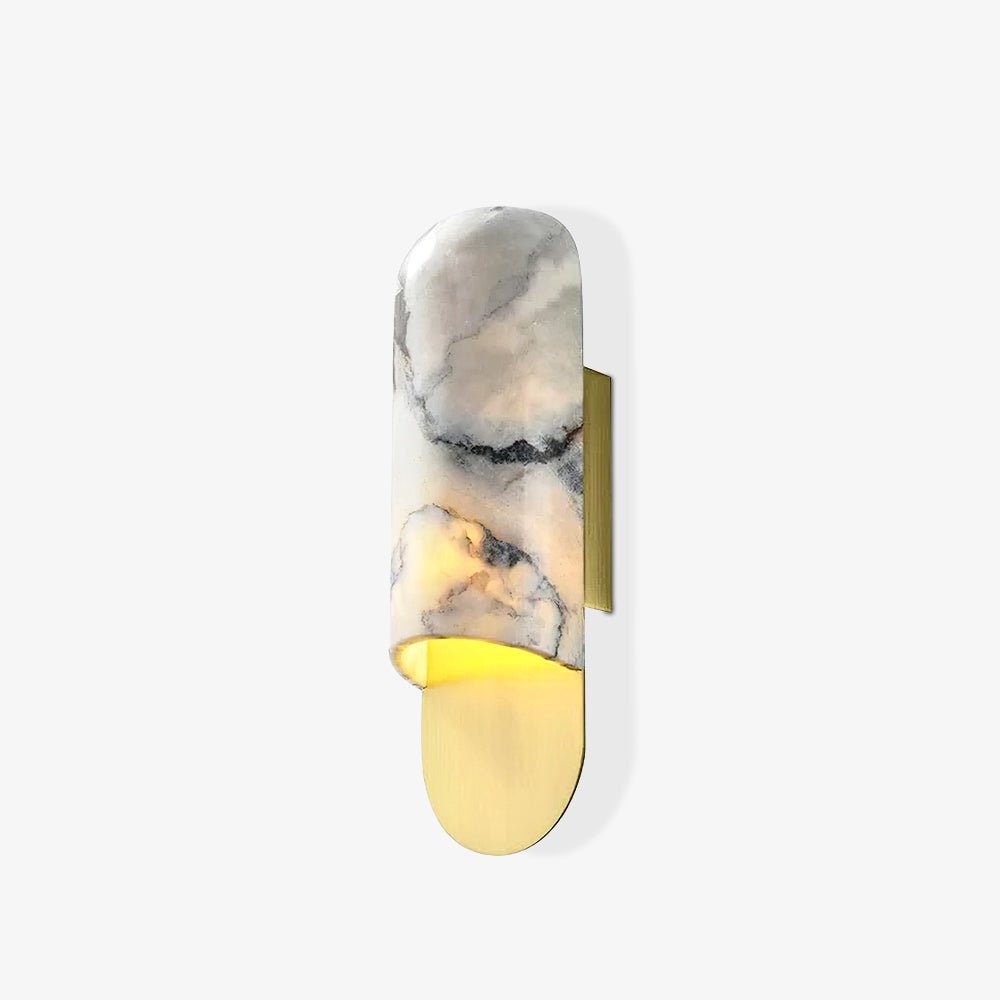 Clérachic marble cylinder wall light with a warm glow at its brass base plate, shown alone on a white background.