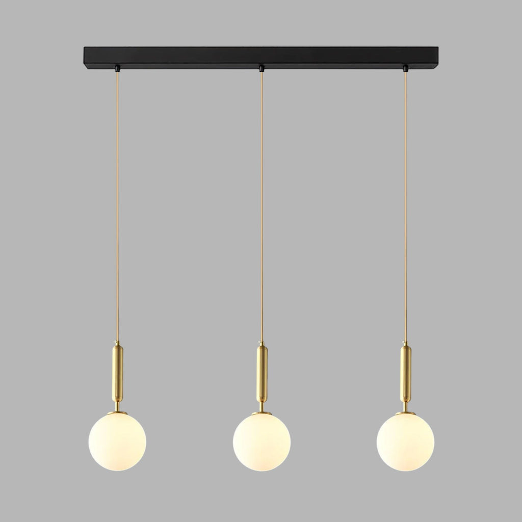 This Clérachic three-head pendant in brass and white hangs from its black bar on grey.