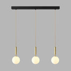 This Clérachic three-head pendant in brass and white hangs from its black bar on grey.