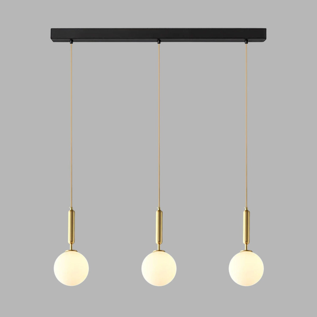 This Clérachic three-head pendant in brass and white hangs from its black bar on grey.