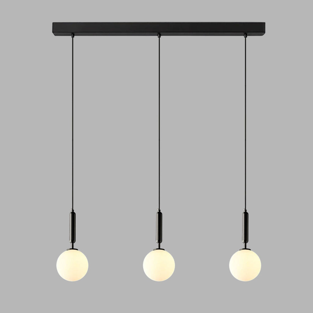 Three slim black-and-white Clérachic sphere pendants hang from a black bar against plain grey.