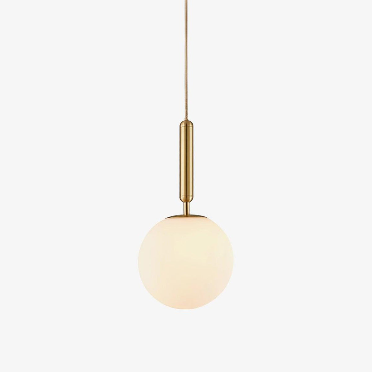 A single Clérachic sphere pendant in brass and white hangs lit against a plain white backdrop.