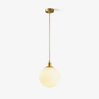 This Clérachic sphere pendant hangs from a rigid brass stem against a plain white backdrop.