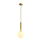 This Clérachic sphere pendant hangs lit on a rigid brass stem against plain white.