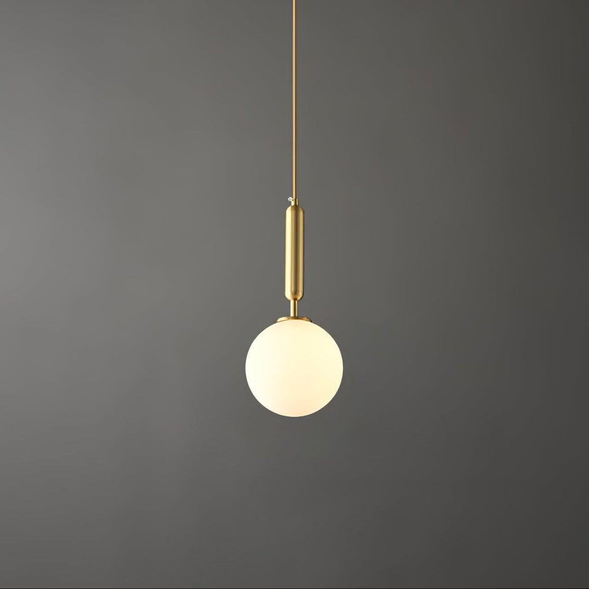 Against the same dark grey backdrop, a brass-and-white Clérachic sphere pendant hangs lit.