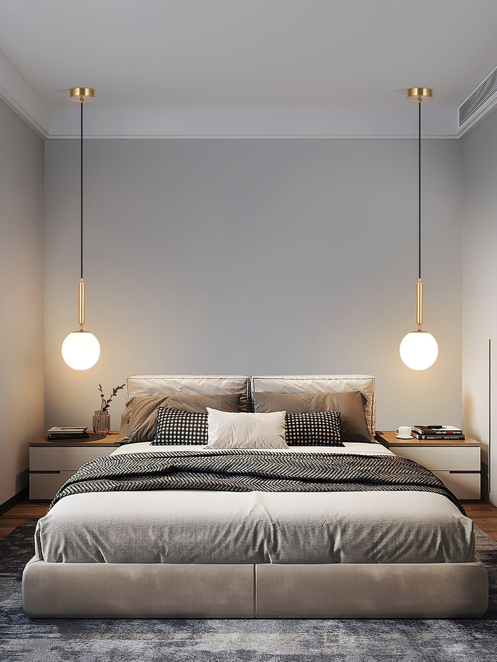 Two black-and-white Clérachic sphere pendants hang symmetrically above a low platform bed.