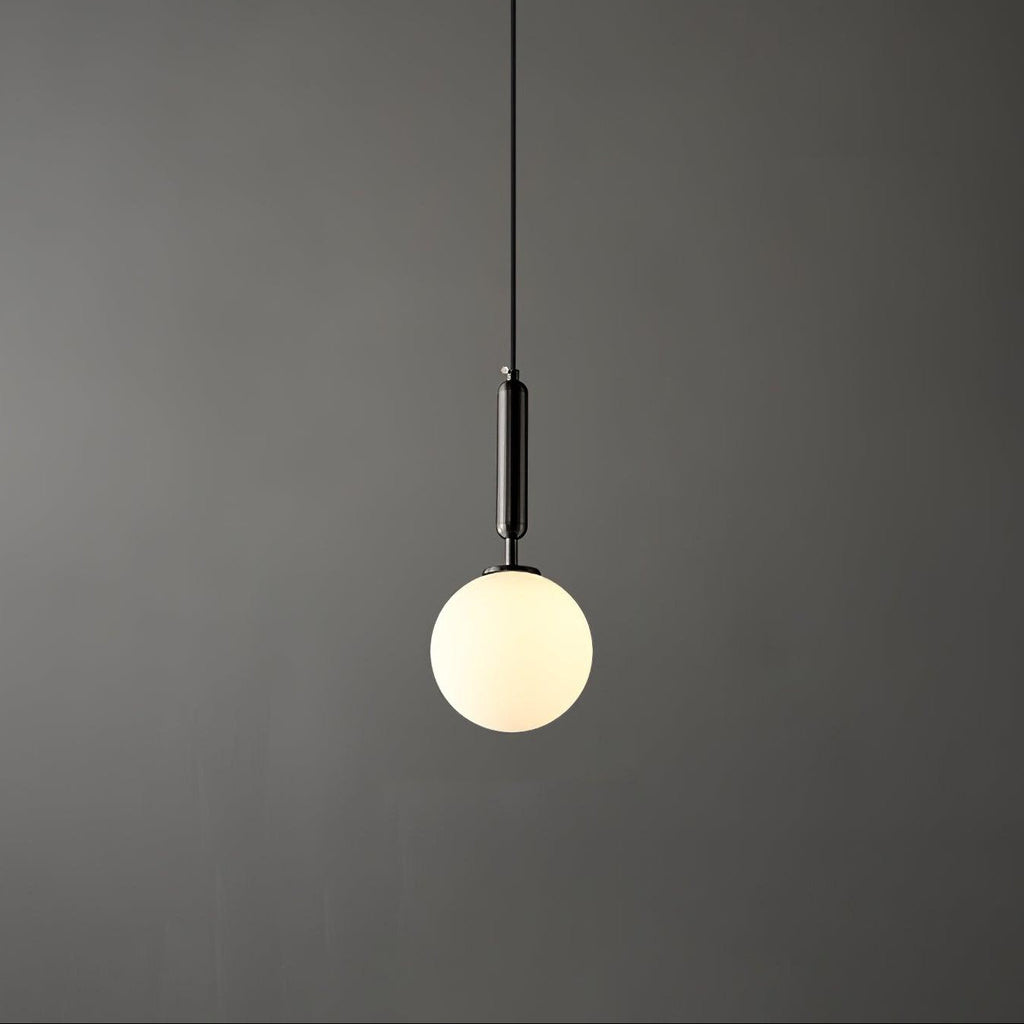 A single black-and-white Clérachic sphere pendant hangs lit against a dark grey studio backdrop.