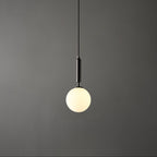 A single black-and-white Clérachic sphere pendant hangs lit against a dark grey studio backdrop.