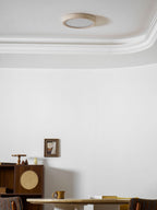 A wider view of the same room shows this Clérachic ceiling light unlit above a cane cabinet, round table and wood chairs.