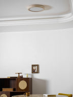 Glowing warmly by the cornice, this Clérachic ceiling light lights the same dining corner with its cane cabinet.