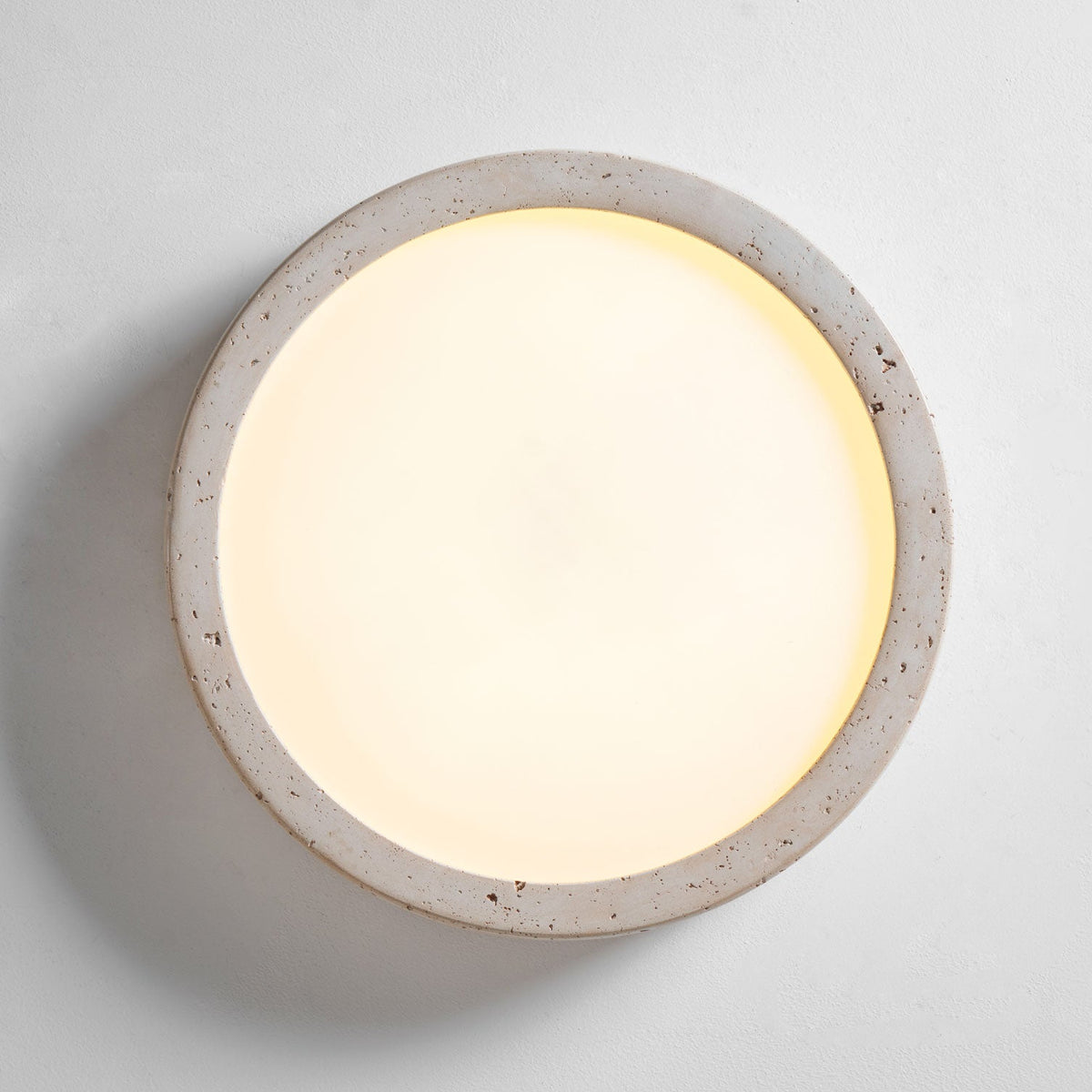 Seen face-on and lit, this Clérachic ceiling light glows warmly across its full white centre panel.