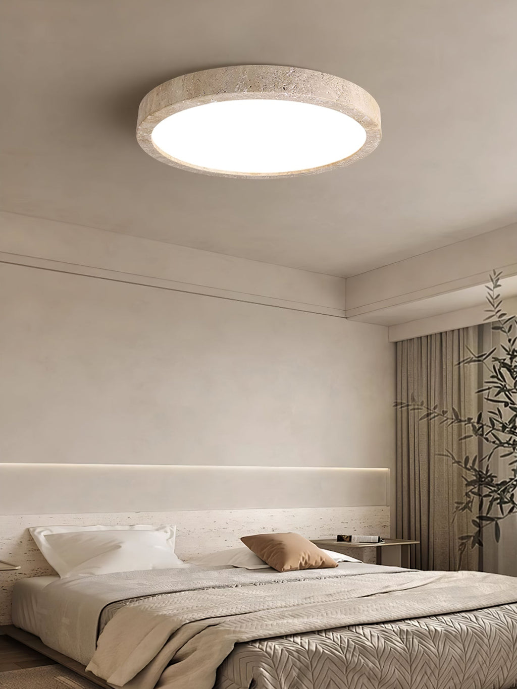 In a bedroom with a cove-lit alcove and a potted plant, this Clérachic ceiling light is mounted flush overhead.