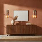 Horsehair wall lamp shown from the side with glass shade lit