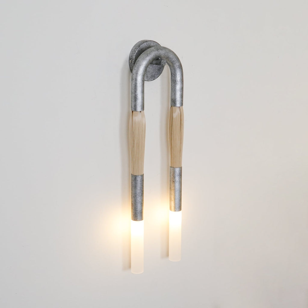 Horsehair wall lamp lit warm as a wall focal point
