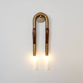 Horsehair wall lamp with flowing mane and white glass shade lit
