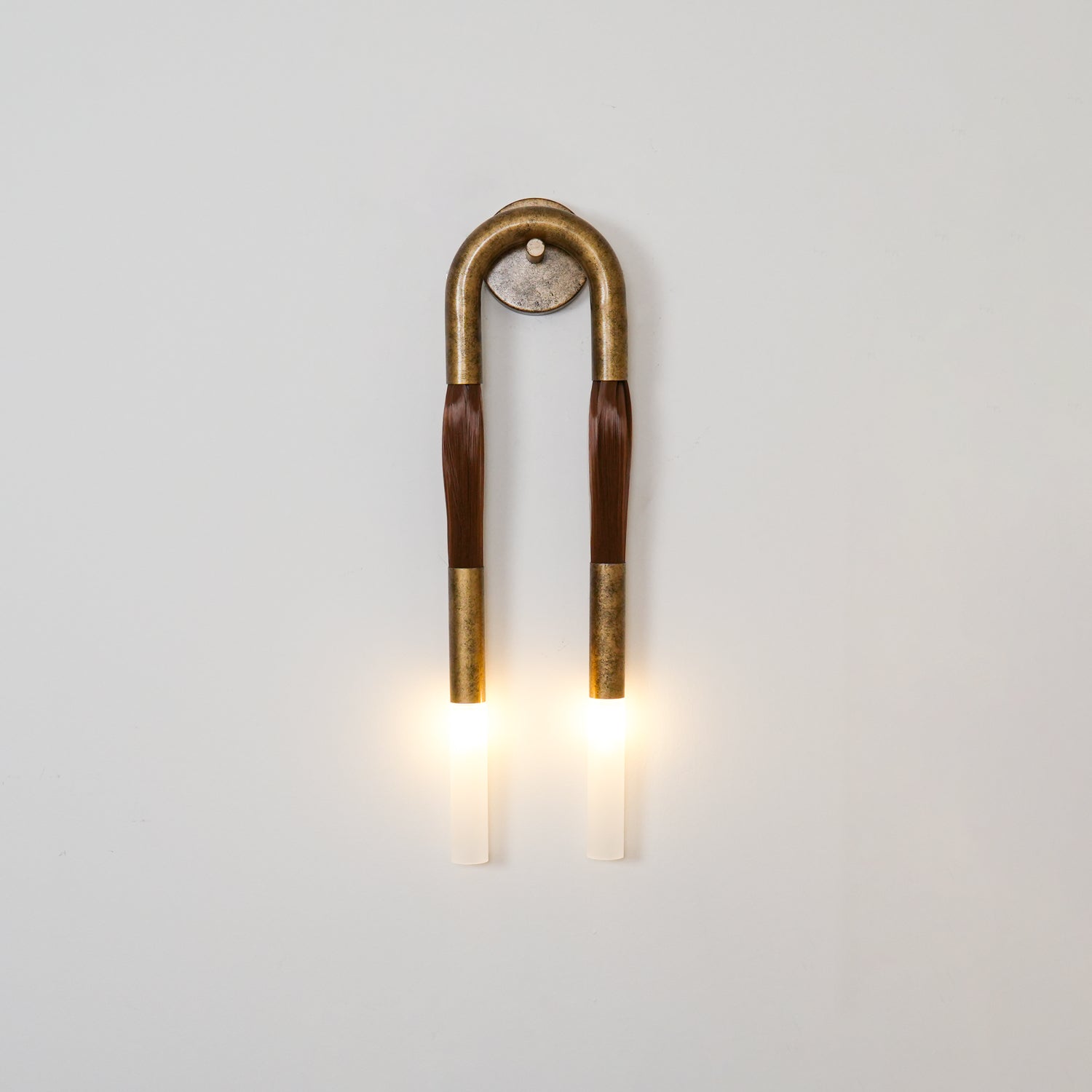Wrought-iron horsehair wall lamp with glowing glass shade