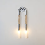 Wrought-iron wall lamp shaped like a horse mane glowing warm