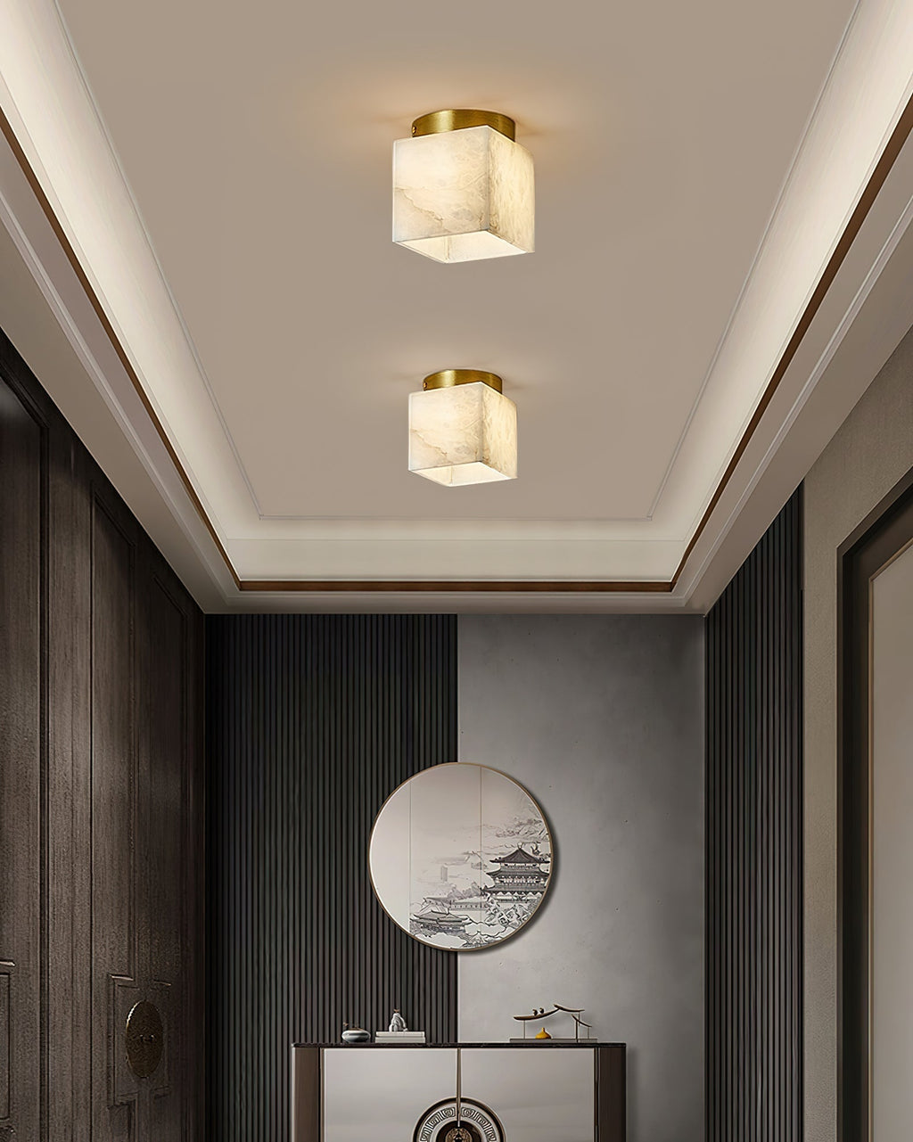 Two Usilia alabaster ceiling lights lit above a hallway console and round mirror, set into a tray ceiling.