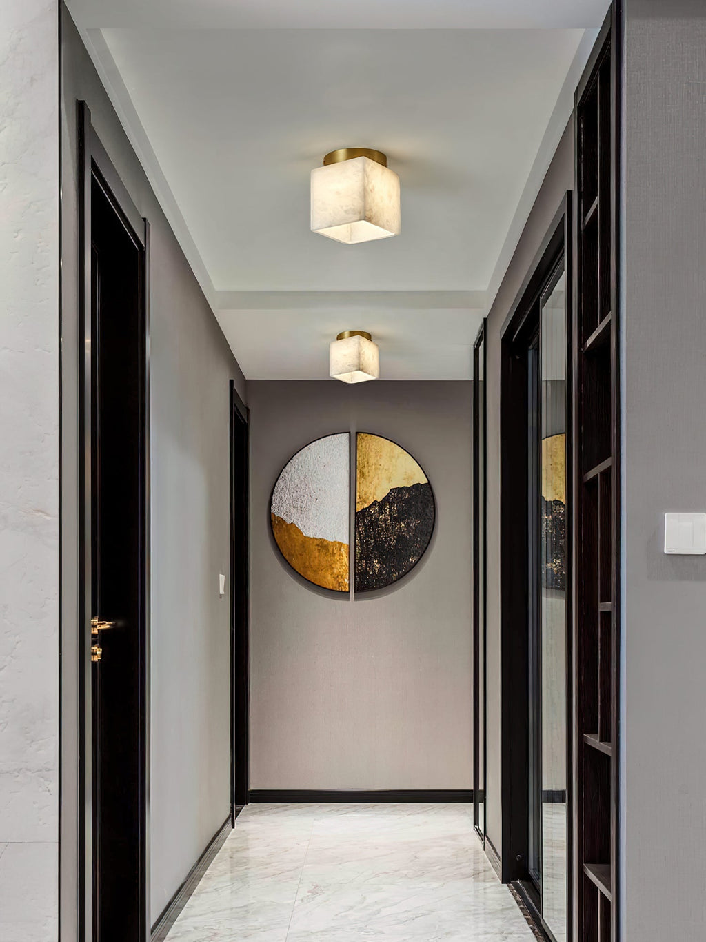 Two Usilia alabaster ceiling lights spaced along a grey corridor ceiling above a marble floor.