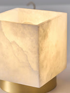 Close-up of the lit alabaster cube, showing the crystalline grain and cut edges of the natural stone shade.