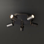 Black barrel-form spotlight ceiling light mounted on a ceiling