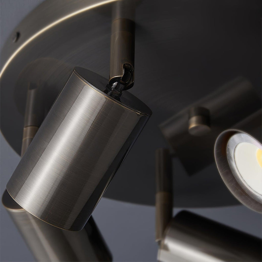 Black spotlight ceiling light angled over a dining area