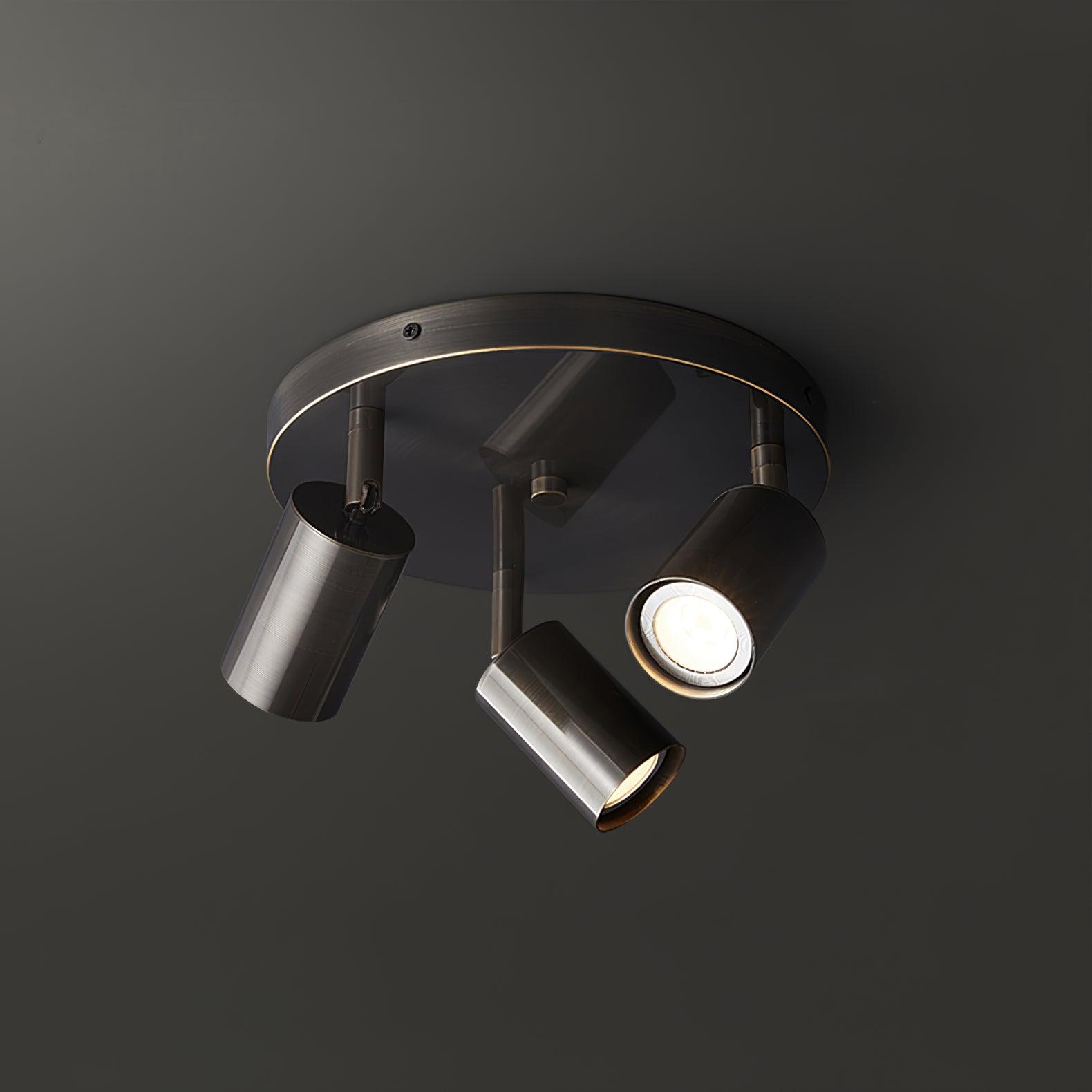 Barrel-form spotlight ceiling light angled over a kitchen island