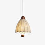 On a plain backdrop, this Clérachic pendant shows its fluted beige shade and wood ball finial beneath the cap.