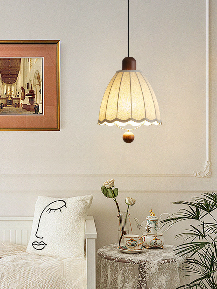 Near framed art and a printed cushion, this Clérachic pendant hangs above a side table set with a tea service.