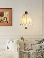 Near framed art and a printed cushion, this Clérachic pendant hangs above a side table set with a tea service.