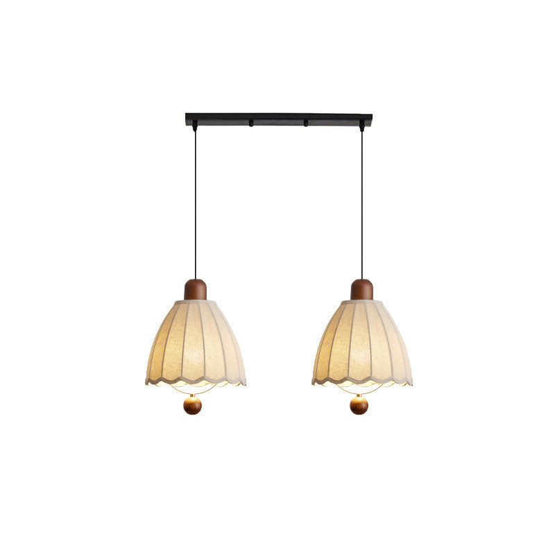 From a linear plate, two of these Clérachic pendants hang with ribbed shades shown against white.