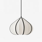 This Clérachic pendant hangs unlit, its tapering shade ribbed in white fabric with bold black seam trim.