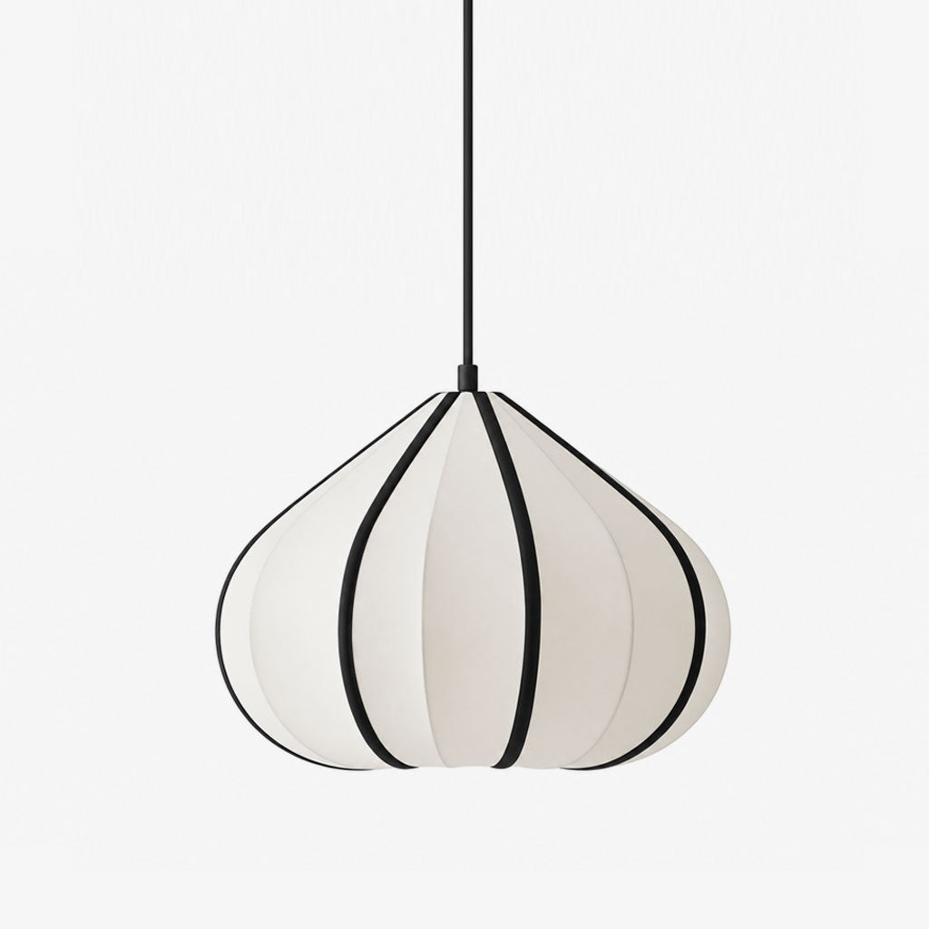 This Clérachic pendant hangs unlit, its tapering shade ribbed in white fabric with bold black seam trim.