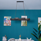 Linear rust iron chandelier with hollow-out mechanical detailing and Edison sockets