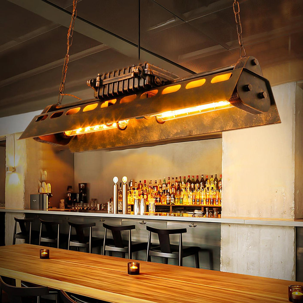 Rust iron linear chandelier with warm Edison glow over a table