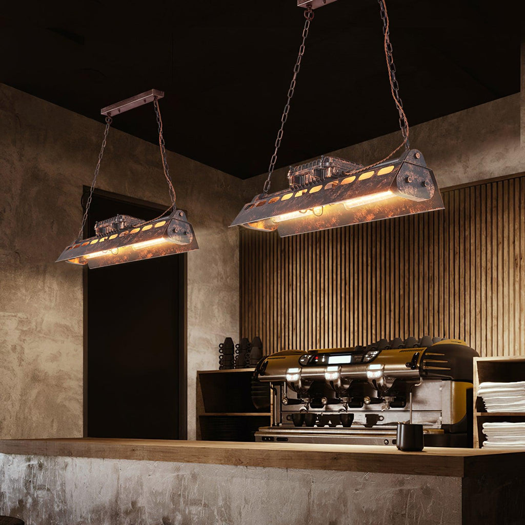 Rust iron linear chandelier glowing with warm amber Edison bulbs