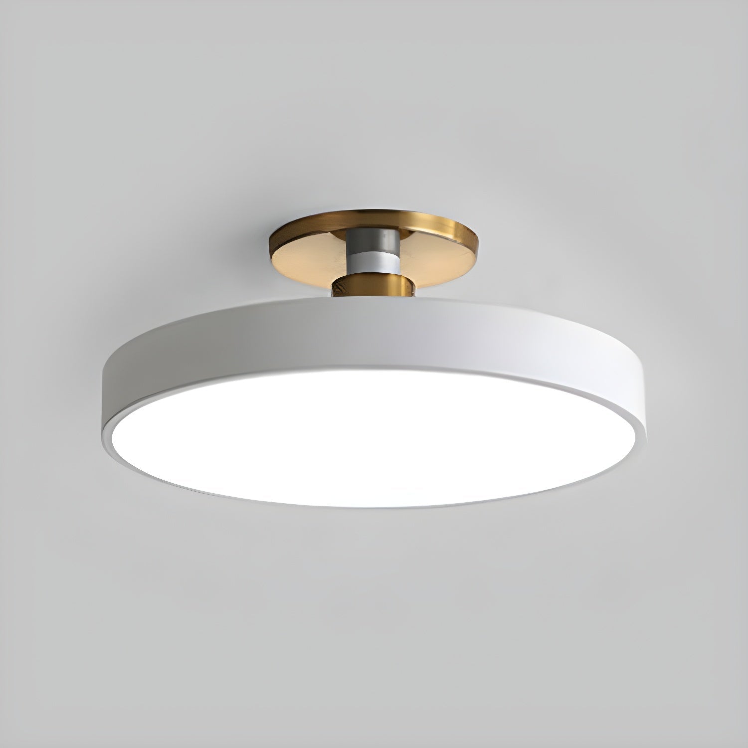 Round flush mount ceiling light glowing softly against a ceiling