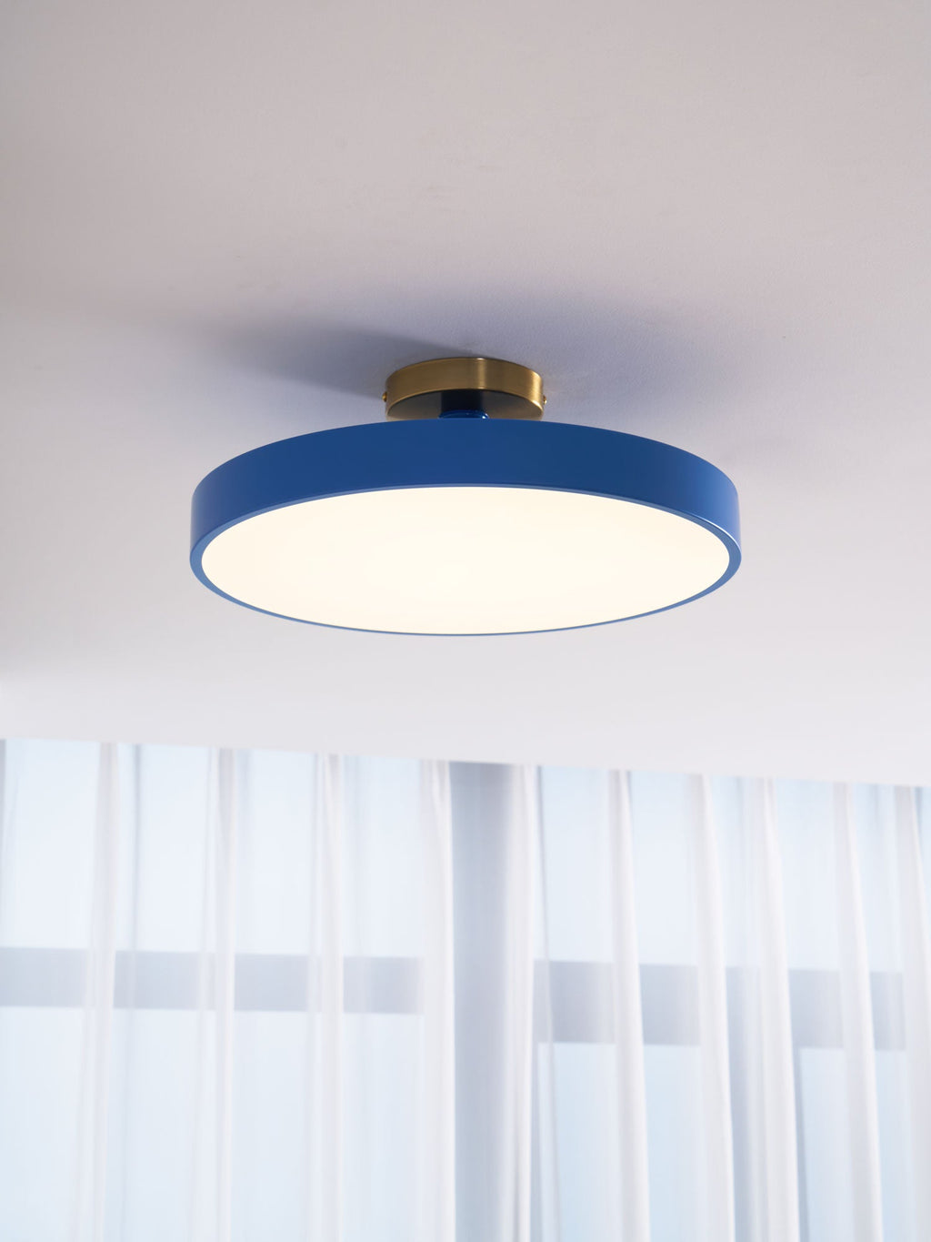 Flush mount ceiling light glowing warmly over a living space