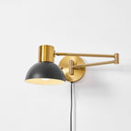Swing arm wall lamp styled in a warm reading corner
