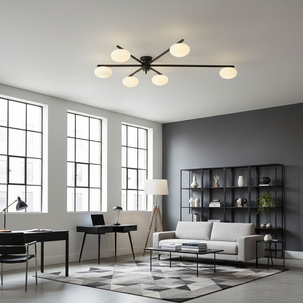 Black ceiling light with white oval shades over a seating area