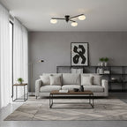 Black ceiling light with slender arms and white oval glass bulbs