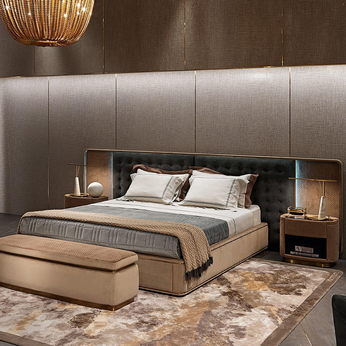 A wider bedroom view shows the Clérachic table lamp glowing on the nightstand, with a storage bench and patterned rug at the foot of the bed.