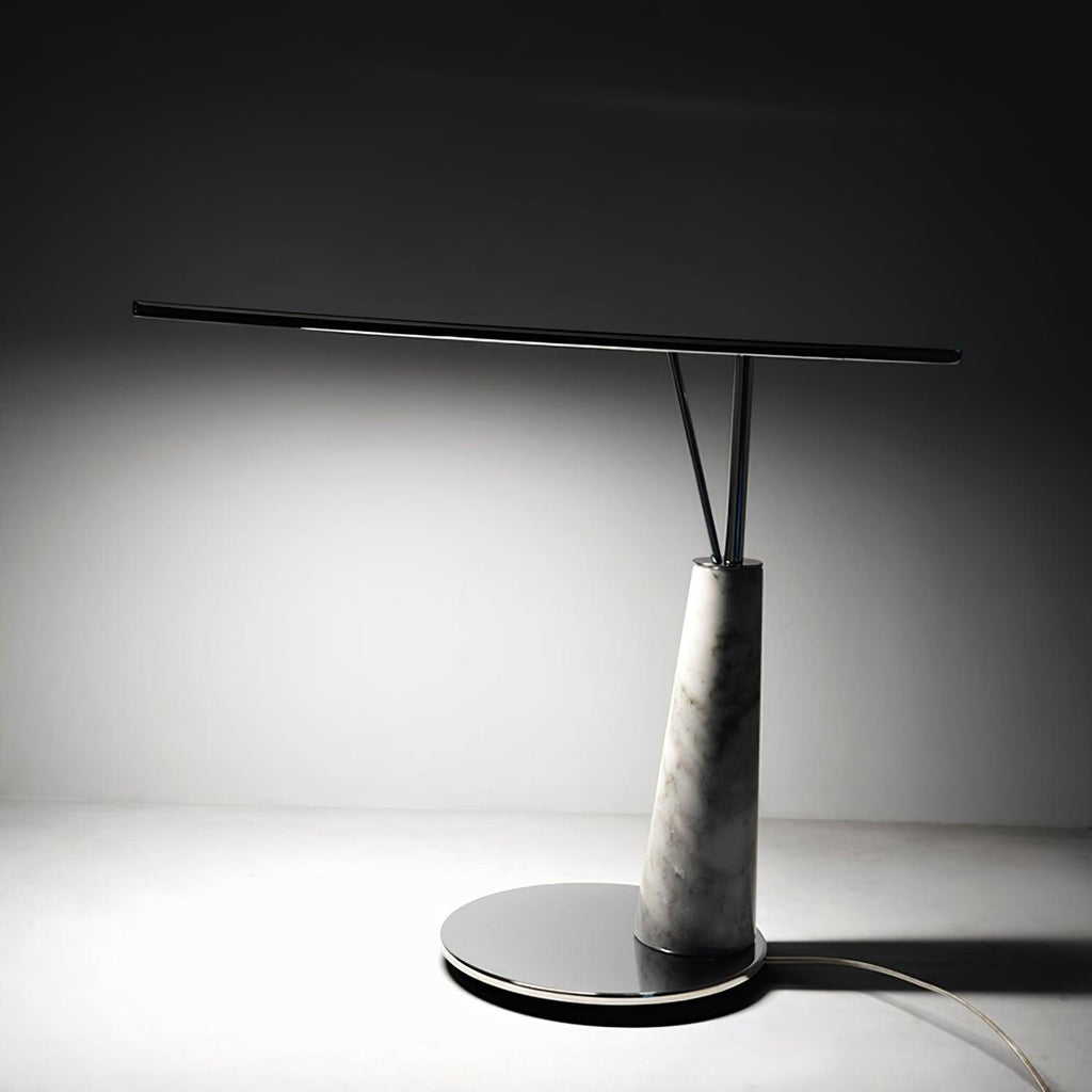 Clérachic table lamp photographed alone on a grey studio backdrop, showing the full marble cone base and slim horizontal LED bar.