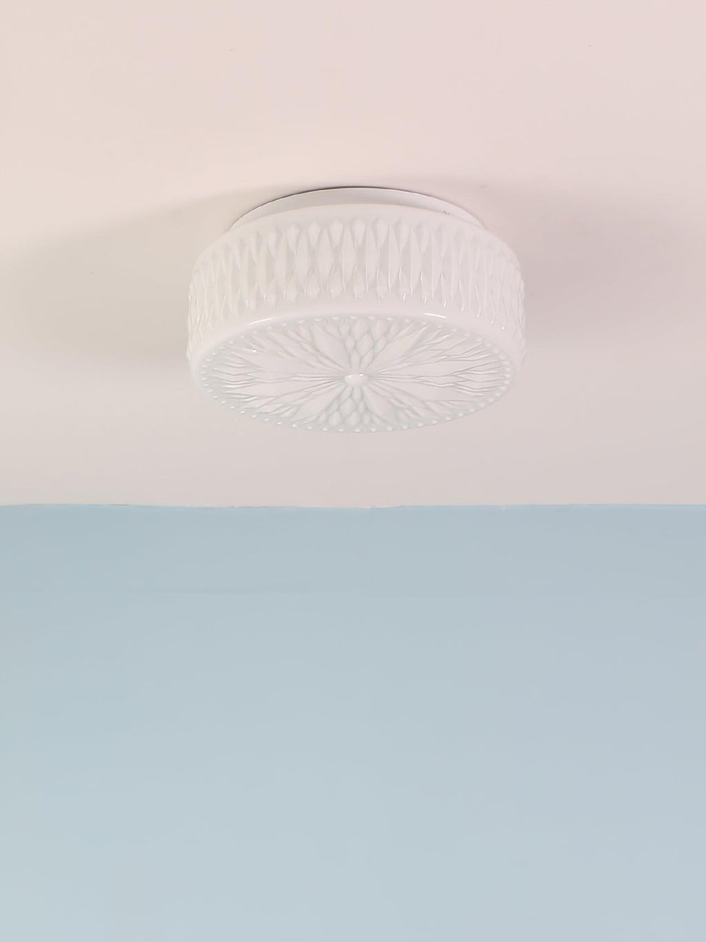 Adler ceiling light detail of the warm beige glass shade