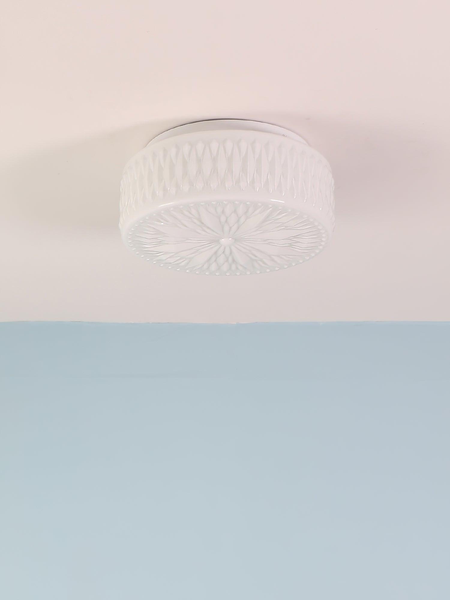 Adler ceiling light detail of the warm beige glass shade