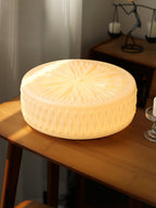 Adler flush mount ceiling light shown lit on a ceiling